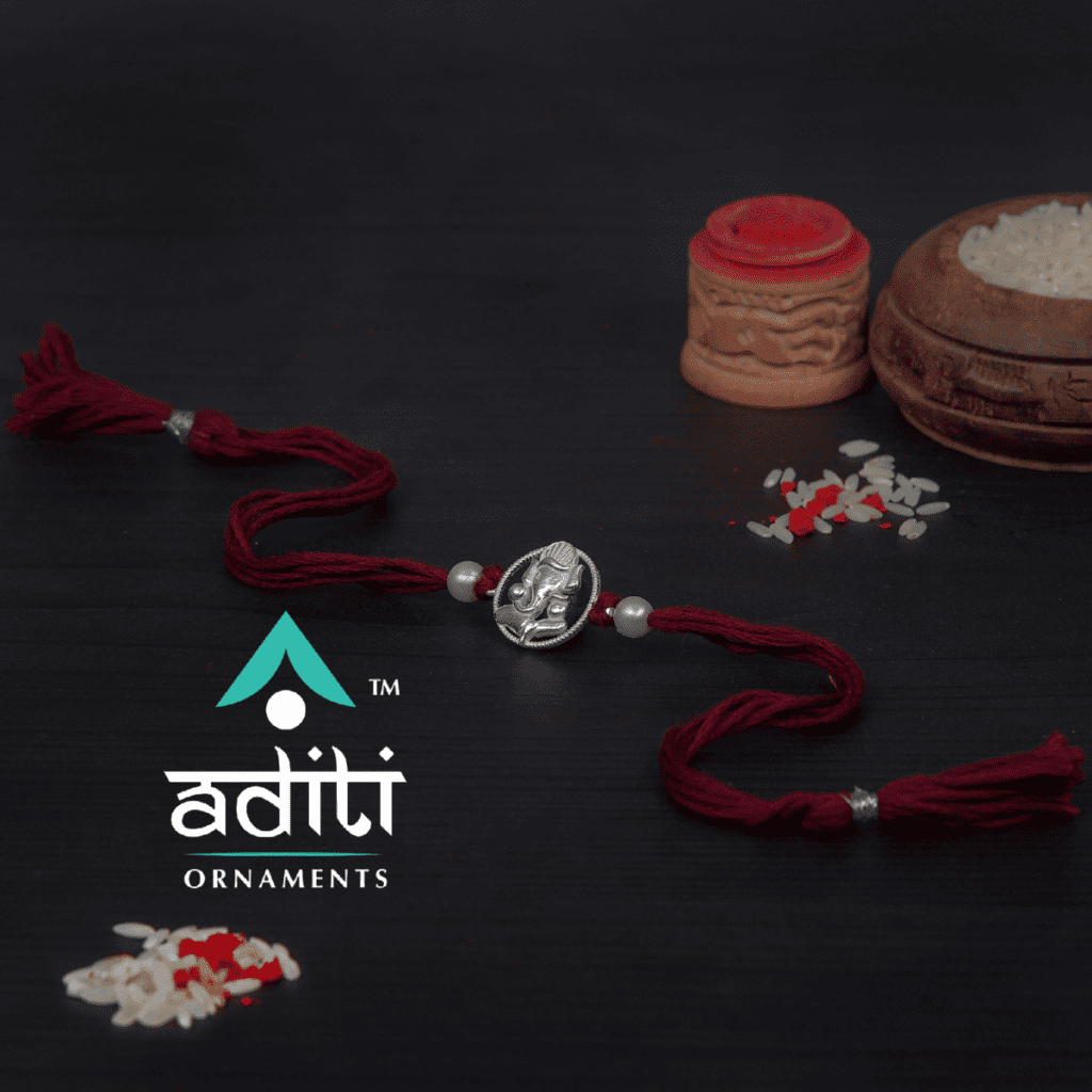 Silver Ganesh Rakhi with Red Moli by Aditi Ornaments, Silver Rakhi Manufacturer, Silver Rakhi Wholesaler